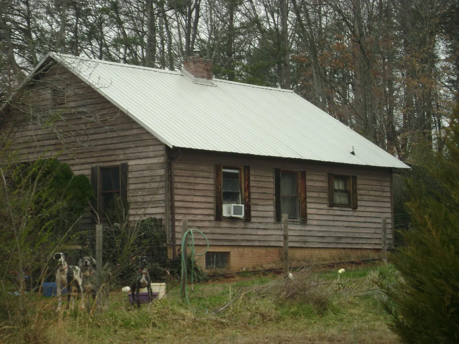 White metal roof on an old wood sided farmhouse, from a Metal Roof Installation job in Guffey
